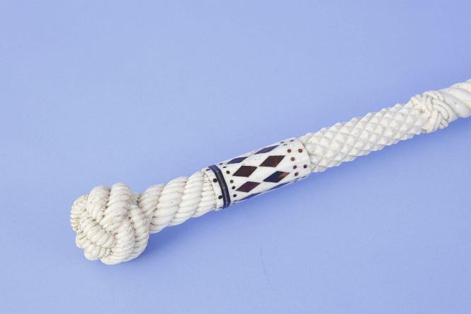 Whale ivory and whale bone cane with finely carved monkey fist and rope grip with  raised diamond and rope carved shaft, mid-19th century