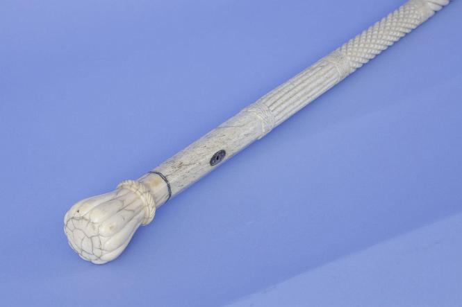 Whale ivory cane with a 12-sided petal grip with whale bone shaft with five carved sections, mid-19th century