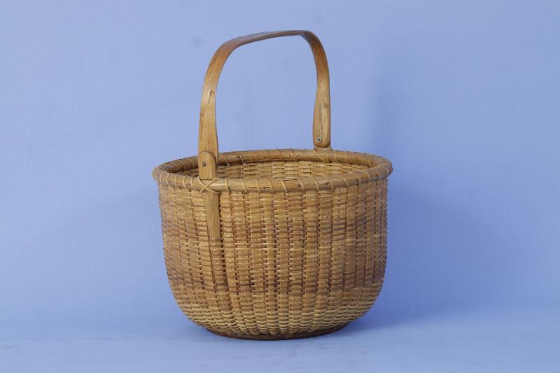 Fine Round Open Nantucket Basket signed Jose Formosa Reyes on the reverse of the base, Nantucket circa 1955.