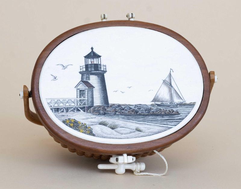 Miniature Nantucket Basket with Ivory Top by Terry Silvia. The basket has a polychrome scrimshaw image of "Brant Point" Lighthouse in Nantucket Harbor. 