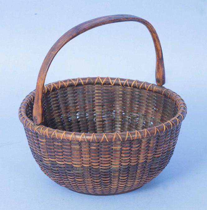 Samuel Crawford (b. 1827) Rare Baleen Stave Woven Round Open Swing Handle Nantucket Basket, with original paper label on base: Made by S.C. Crawford, Nantucket, Mass.

Height 4 in. Diameter 8.5 in.

Provenance: The John M. Deciccio Collection, Nantucket Island, Massachusetts
